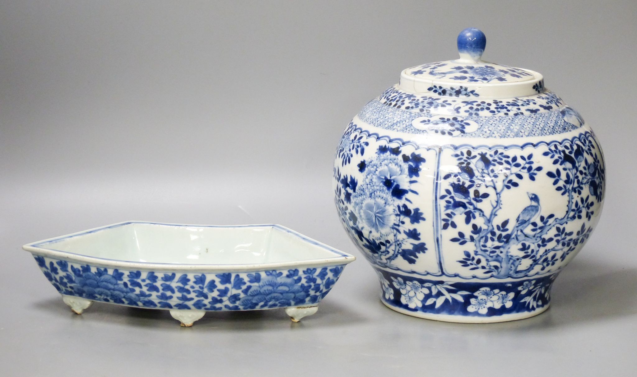 A 19th century Chinese blue and white jar and cover, four character Kangxi mark, 22cm high and a Chinese blue and white fan shape dish, 25.5cm